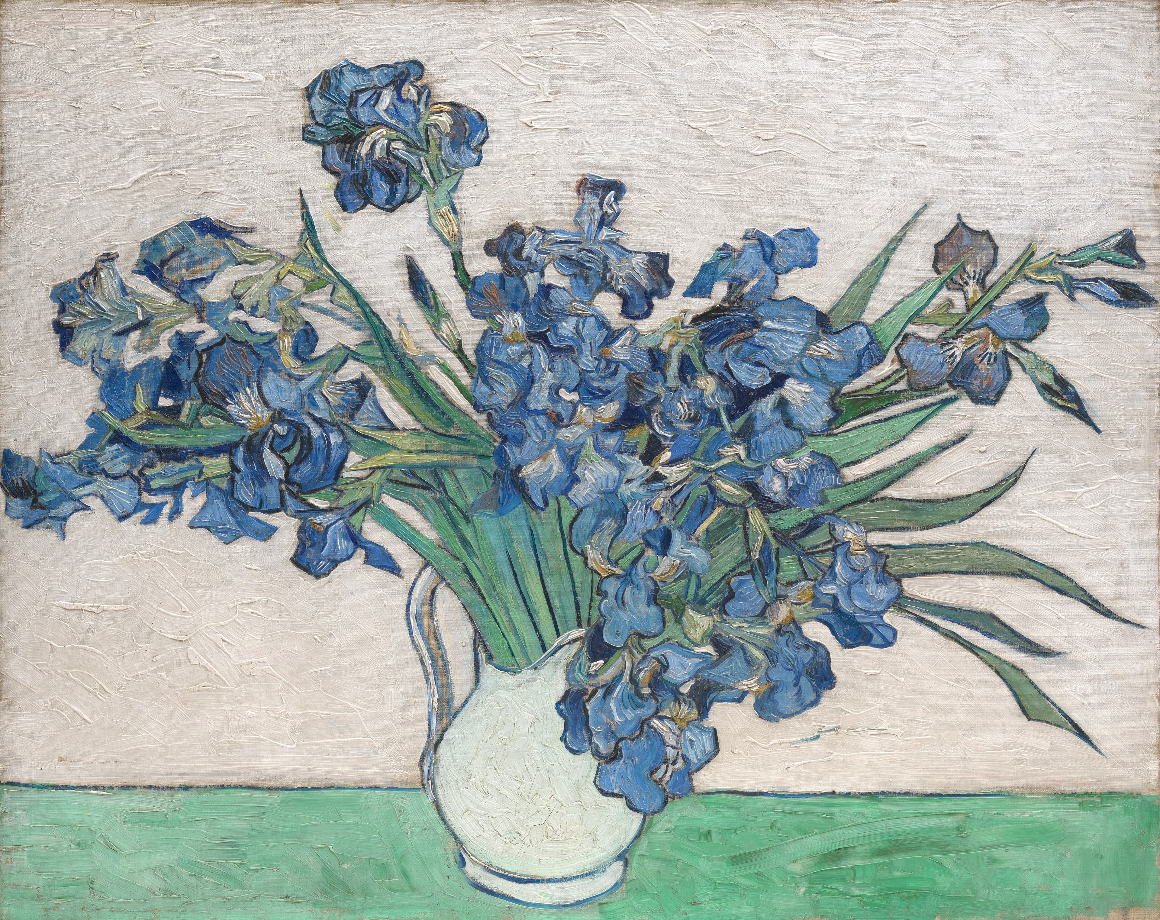 Blue irises arranged in a white vase
